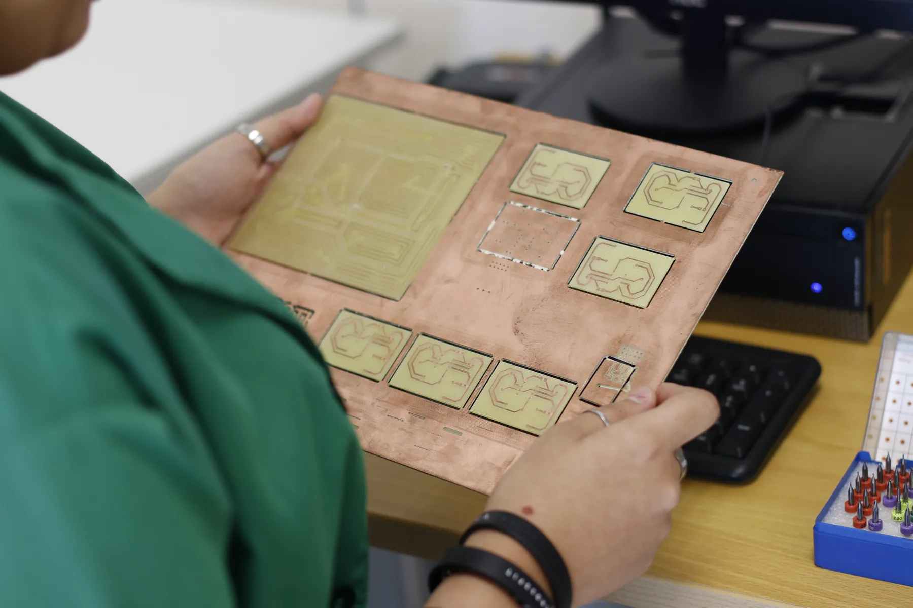Technician inspecting a circuit board during hardware development